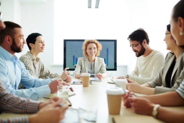 Executives meet in a board room.