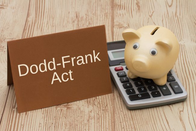 Dodd-Frank Act sign with piggy bank, calculator