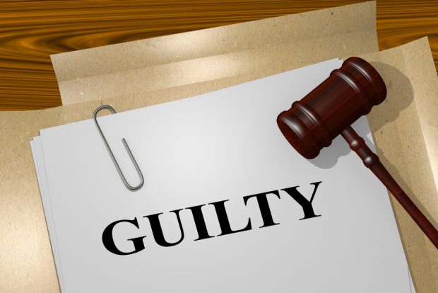 File with the word "guilty" typed on it sitting next to a gavel