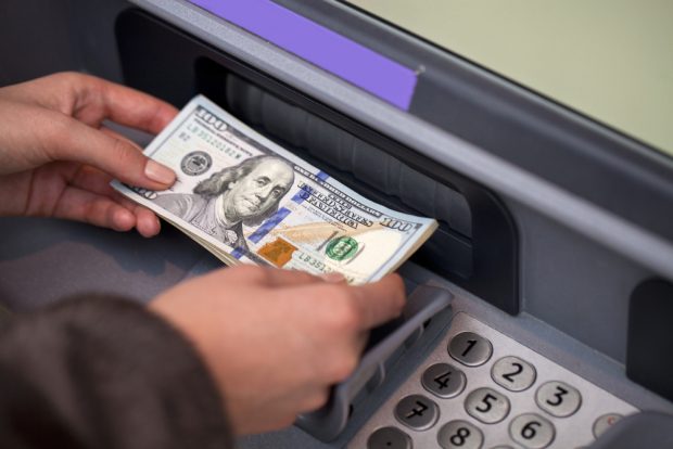Depositing money into an ATM.
