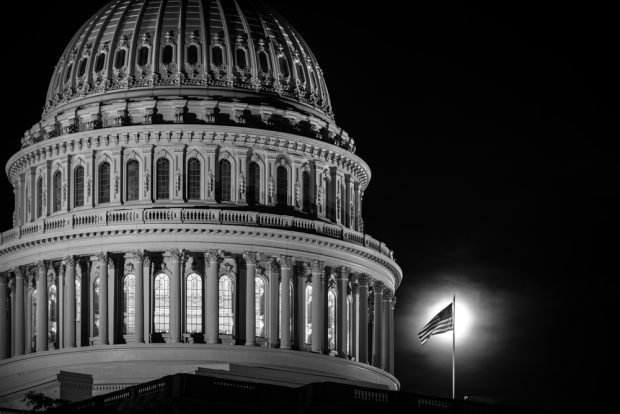 Dome of U.S. Capitol in a black and white photo.