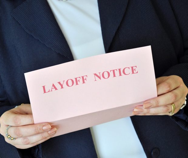 Woman holding a layoff notice letter