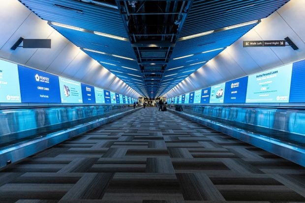 PenFed Credit Union Marketing Campaign Takes Over Concourse C Connector at Washington Dulles International Airport (Source: Clear Channel Outdoor Holdings).