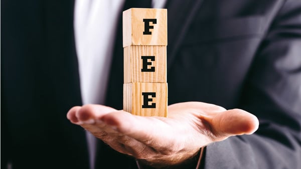 hands holding blocks that spell out 'fee'