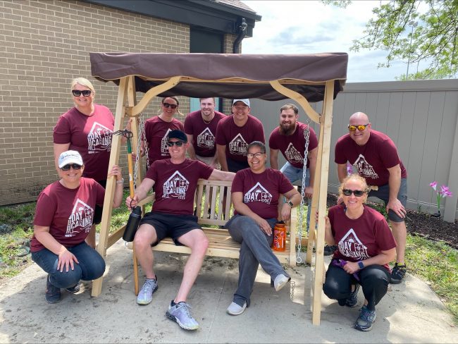 Klein (sitting on bench, left) with a team of coworkers after spending a day volunteering for a United Way Day of Caring event in Eastern Iowa last year