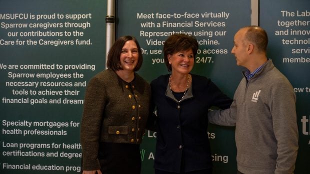 MSUFCU President and CEO April Clobes, Regional System President at University of Michigan Health Margaret Dimond, Ph.D., and Lansing Mayor Andy Schor at the announcement of MSUFCU and Sparrow's new partnership. Credit/MSUFCU