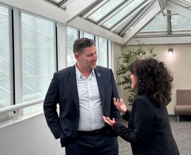 Jason Wolkove (left) talks with Premier America Chief Experience Officer Marci Francisco at the credit union's most recent Annual Meeting at its corporate headquarters in Chatsworth, Calif.