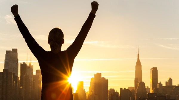 Successful woman holding her arms up