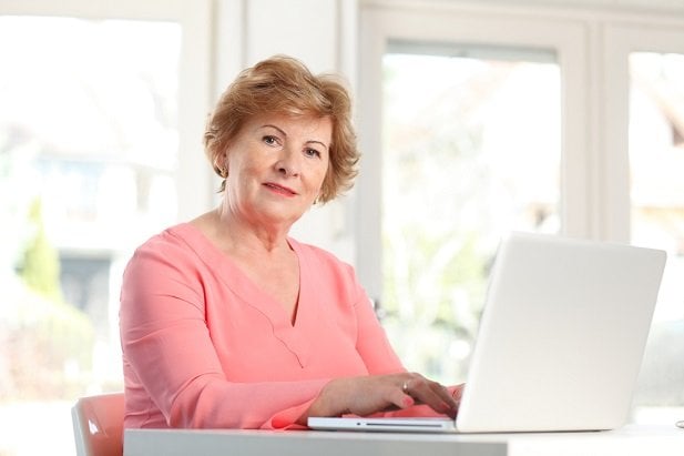 Middle-aged woman working on laptop