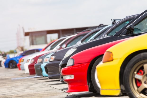 new cars lined up at an auto dealership