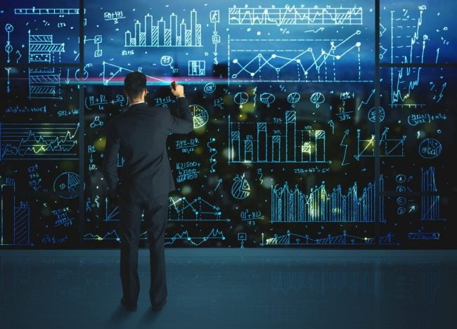 Man working on a full wall of data