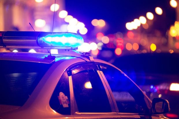 Police cars with lights on blocking a crime scene