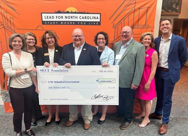 From left to right: SECU Foundation Board Members Jennifer Haygood and Mona Moon; SECU President/CEO Leigh Brady; SECU Foundation Board Member Ben McLawhorn; UNC School of Government Dean Aimee Wall; SECU Foundation Director of Grants Administration Scott Southern; SECU Foundation Executive Director Jama Campbell and LFNC Executive Director Dylan Russell