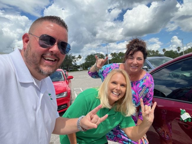 Lewis (center) participates in USF FCU's Grassroots 