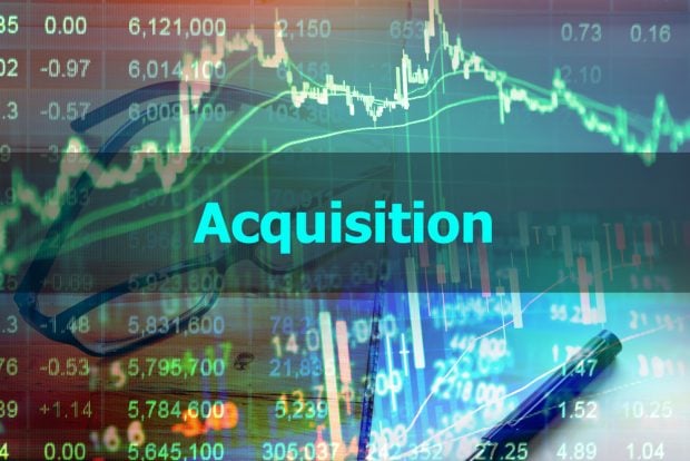 acquisition sign over stock prices and economic charts