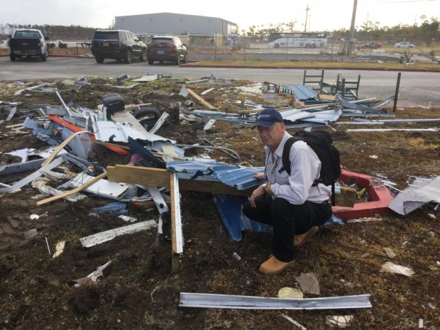Bruce Foulke, president/CEO of American Heritage FCU, amid some of the debris left by Hurricane Dorian on Grand Bahama during a visit Sept. 12.
