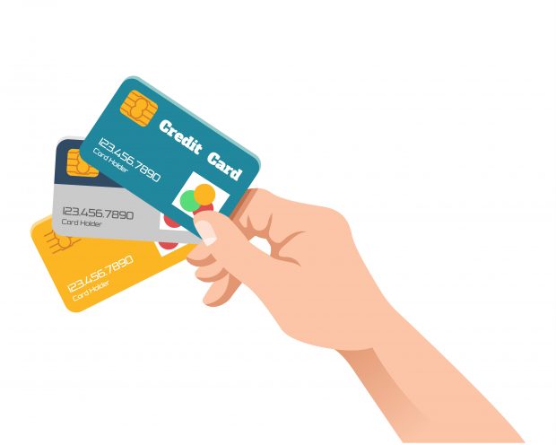 Hand holding credit and debit cards.