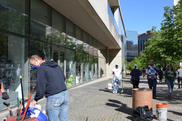 Volunteers clean up downtown Grand Rapids, Mich. after windows were broken during protests.
