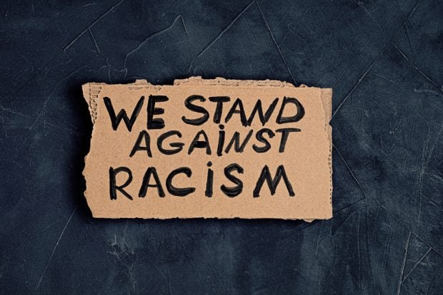 We Stand Against Racism sign