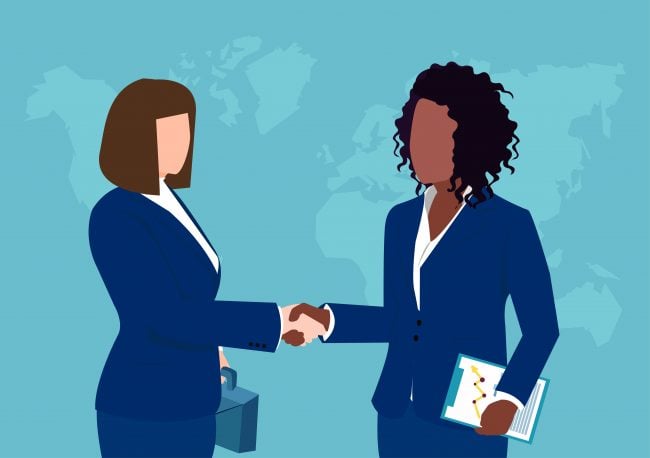 Vector of two businesswomen shaking hands isolated on world map background.