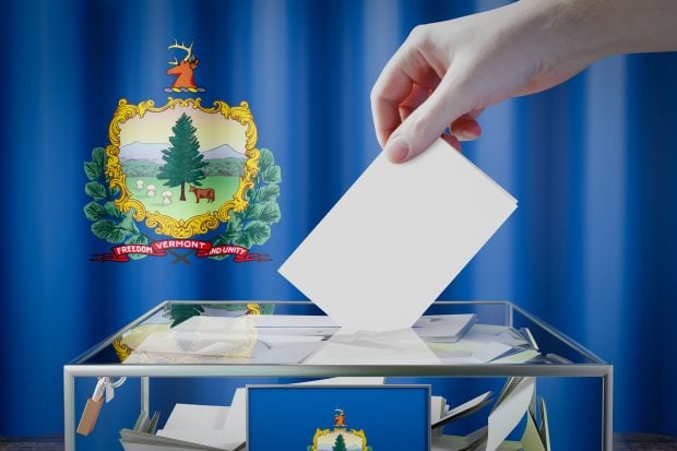 Vermont flag, hand dropping ballot card into a box - voting, election concept - 3D illustration