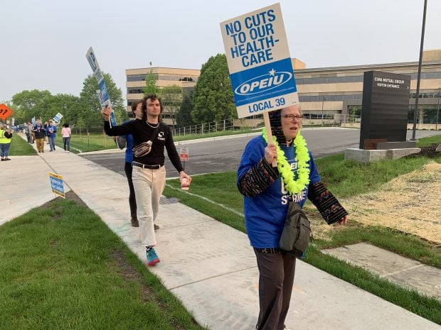 Union employees picket in front of CUNA Mutual Group headquarters in Madison, Wis. on May 19, 2023.