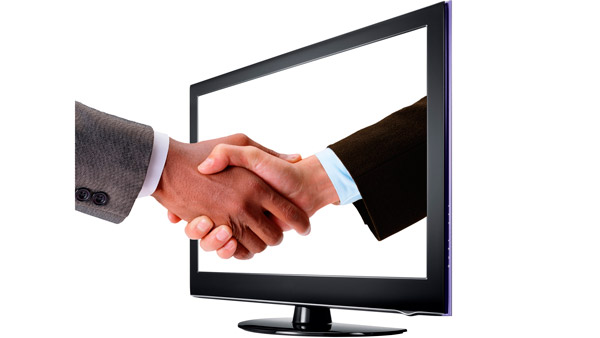 handshake through computer monitor screen