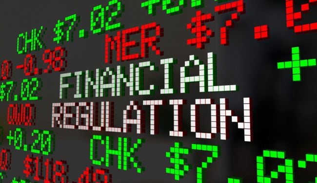 Financial regulation text on lit-up board