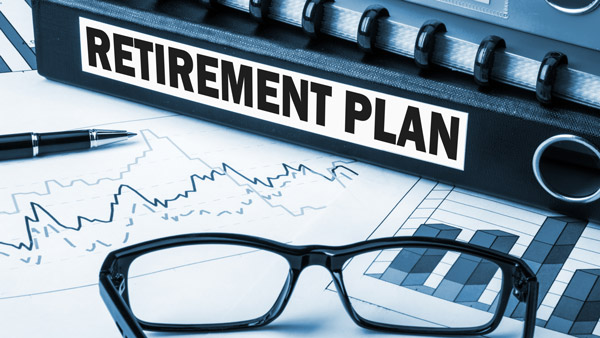 Retirement plan folder on top of financial planning documents