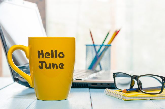 "hello june" written on coffee mug on desk