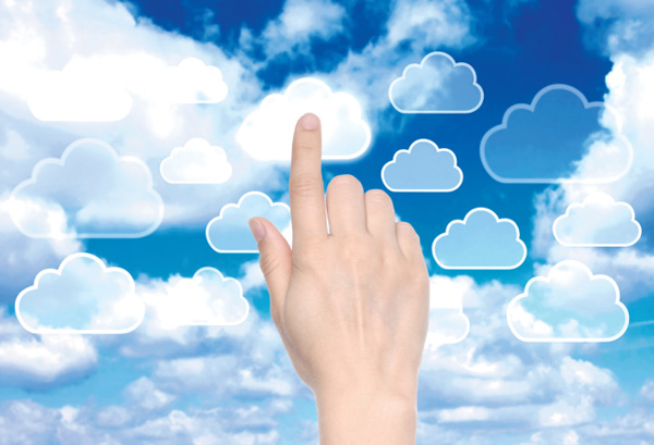 Finger pointing at clouds in sky