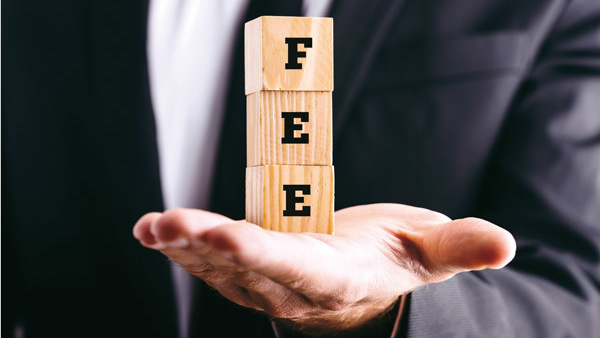 businessman holding blocks spelling out "fee"