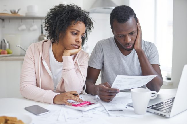 Stressed out couple reviewing bills
