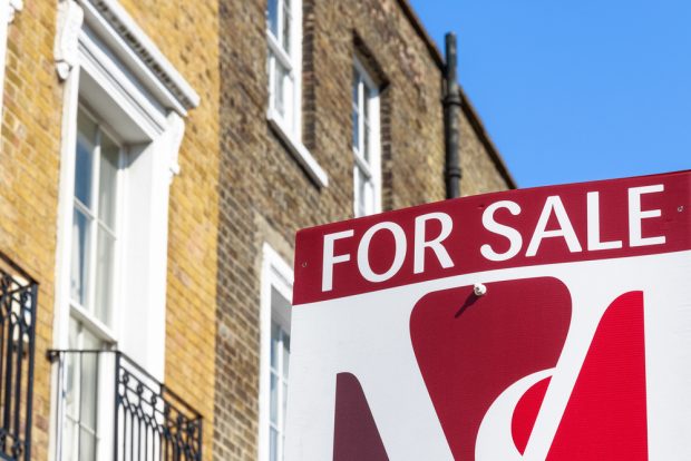 For Sale sign in front of a house.