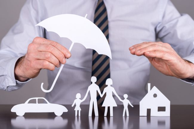 businessman with umbrella covering car, family and home