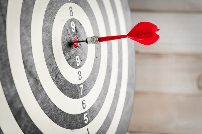 dart in the bull's eye of a dart board