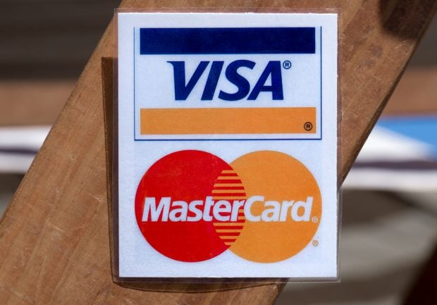 Visa and Mastercard sign at a retailer.