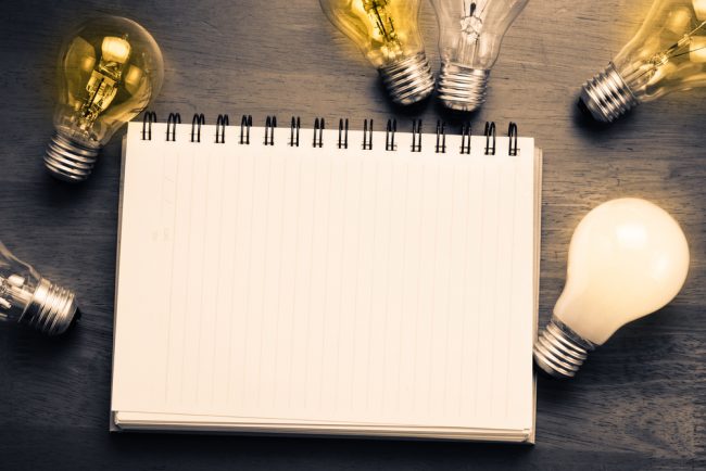 Blank notebook with lightbulbs