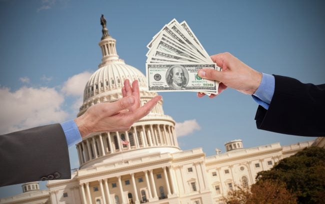 money exchanging hands in front of the U.S. Capitol.