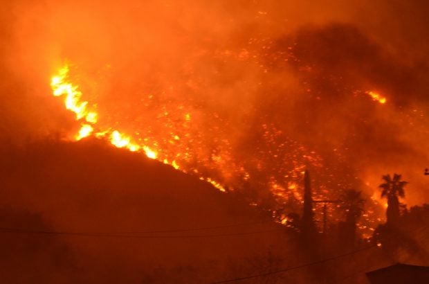 Wildfire burning on the side of a mountain