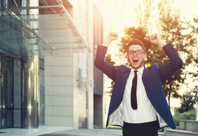 businessman cheering outdoors