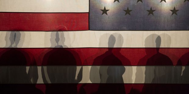 shadows of people cast on the American flag.