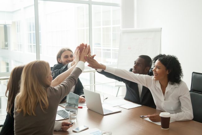 Coworkers high-fiving