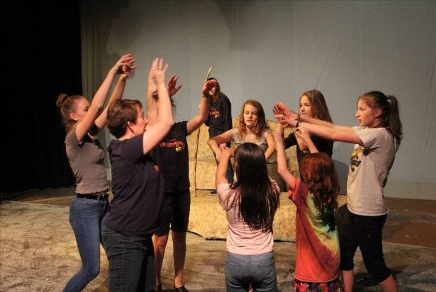 Point West CU President/CEO Amy Nelson rehearses with youth community theatre performers.