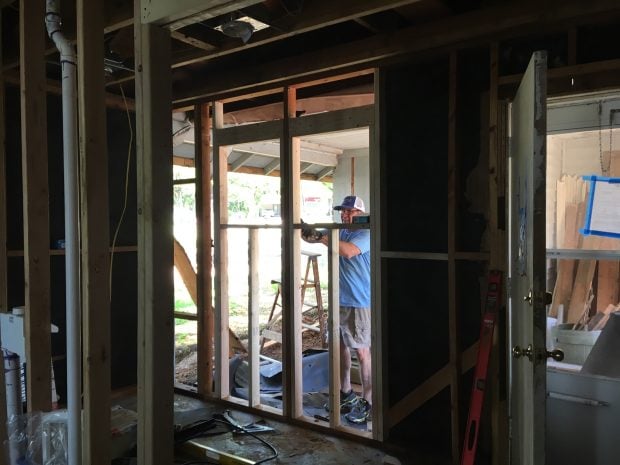 Jim Minge doing demo work of an old home to remodel. (Source