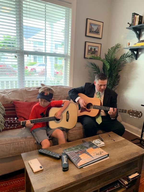 Latitude 32 CU President/CEO Marcus Rhymer playing guitar with his son. (Source: Marcus Rhymer)