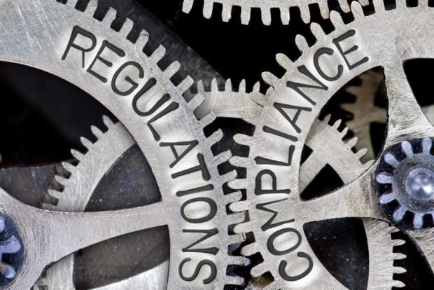 regulations and compliance gears locked together