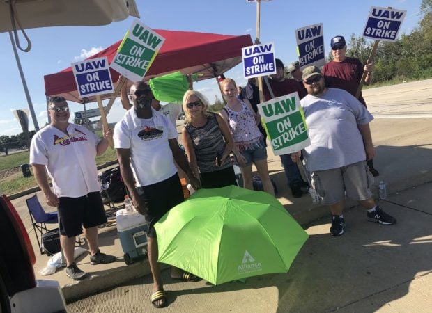 Alliance Credit Union posted this photo on Facebook of branch manager Rose Ann Cuddy, center, bringing lunch and umbrellas to workers on the picket lines at the GM Wentzville Assembly Center Tuesday.