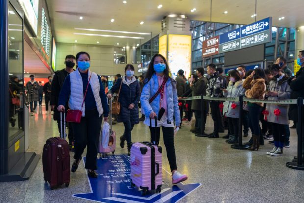 Chengdu, Sichuan / China - January 23 2019: travellers all wear mask at airport to prevent infection from coronavirus.