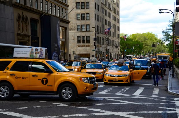 Yellow New York City Taxi driving in Midtown, Manhattan.